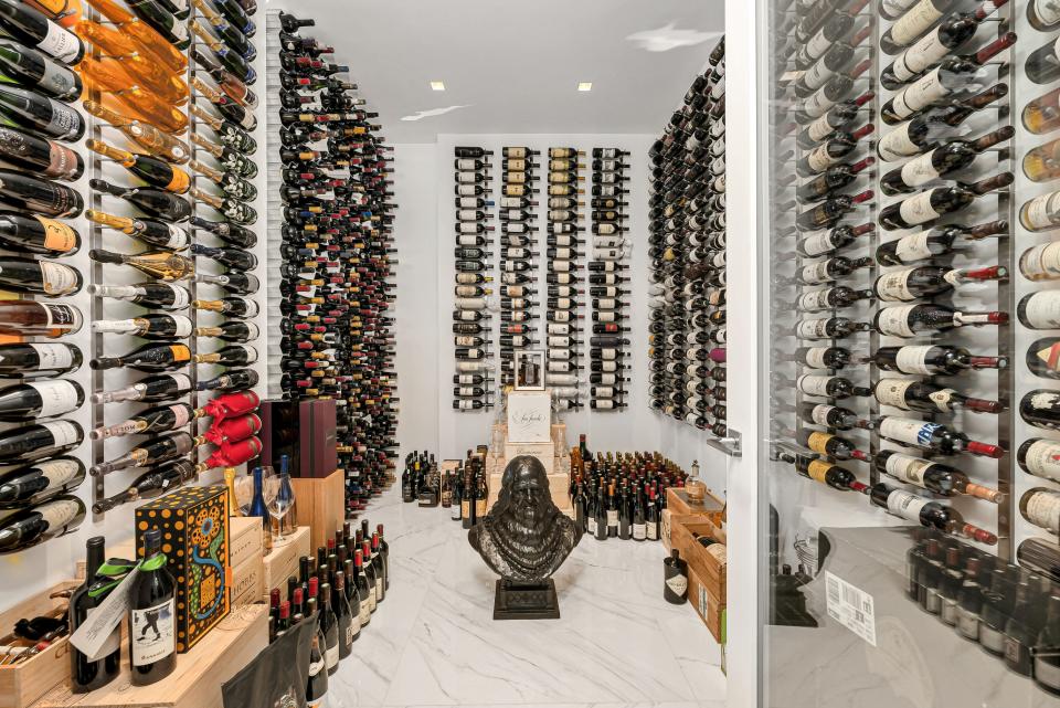 This wine cellar holds about 3,000 wine bottles. One of the walls has a honeycomb shape that the bottle stick into. On the other side of the wall, that honeycomb becomes a work of art in the kitchen.