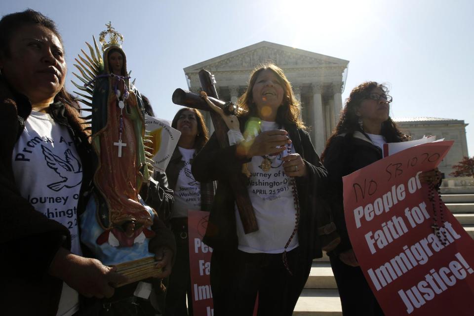 Opponents of Arizona's "show me your papers" immigration law rally in front of the Supreme Court in Washington, Wednesday, April 25, 2012, as the court held a hearing . (AP Photo/Charles Dharapak)