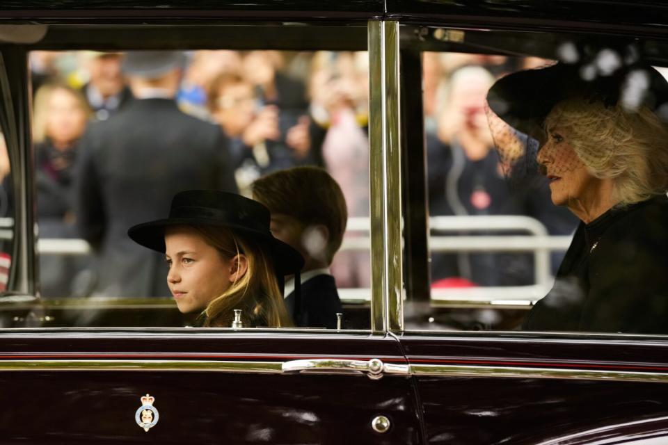 Princess Charlotte and Prince George ride in a car with the queen consort, Camilla.