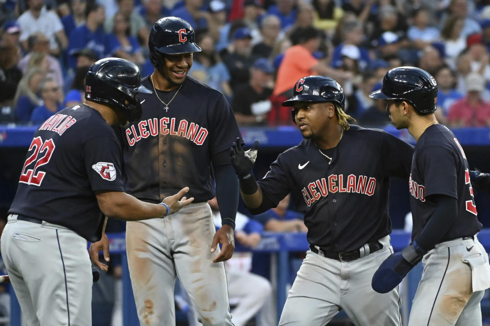 Cleveland Guardians' Josh Naylor, Will Benson, Jose Ramirez and Steven Kwan, from left, celebrate Ramirez's three-run home run against the Toronto Blue Jays during the fourth inning of a baseball game Friday, Aug. 12, 2022, in Toronto. (Jon Blacker/The Canadian Press via AP)