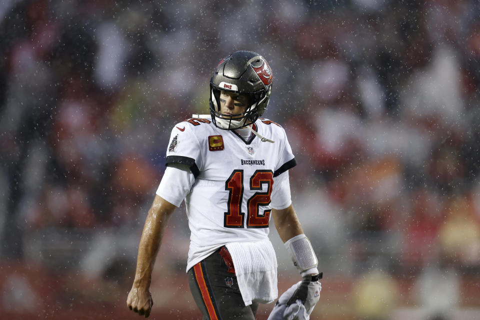 Rain falls as Tampa Bay Buccaneers quarterback Tom Brady walks on the field during the second half of an NFL football game against the San Francisco 49ers in Santa Clara, Calif., Sunday, Dec. 11, 2022. (AP Photo/Jed Jacobsohn)