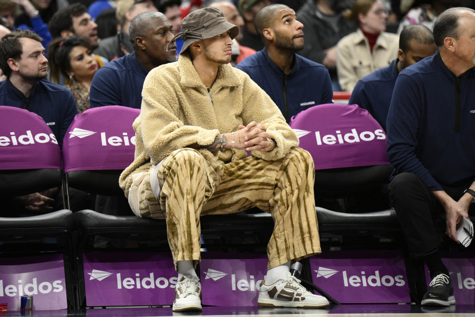 Washington Wizards forward Kyle Kuzma watches from the bench in street clothes during the first half of an NBA basketball game against the Cleveland Cavaliers, Monday, Feb. 6, 2023, in Washington. (AP Photo/Nick Wass)