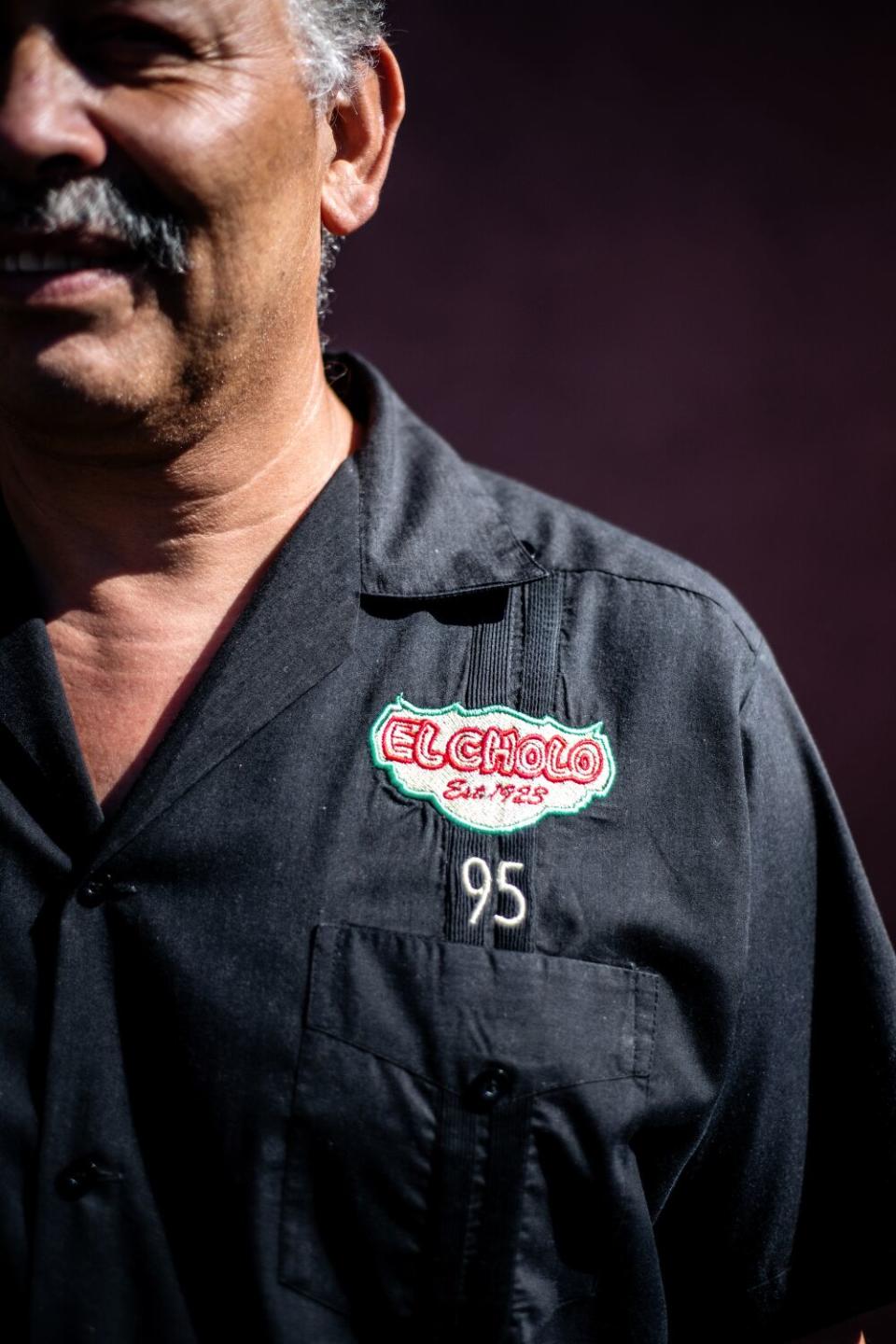 A close up of Jaime Cornelio's shirt, which reads "El Cholo, est. 1923, 95"