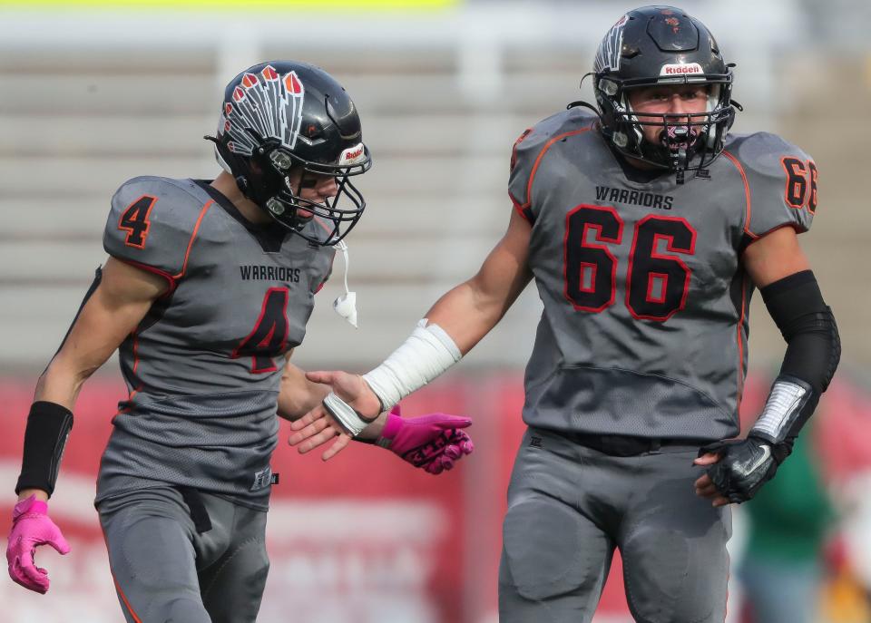 Black Hawk/Warren's Will Stietz (66) celebrates with Lane Marty (4) after making a tackle for loss against Edgar High School during the WIAA Division 7 state championship football game on Thursday, November 16, 2023, at Camp Randall Stadium in Madison, Wis.