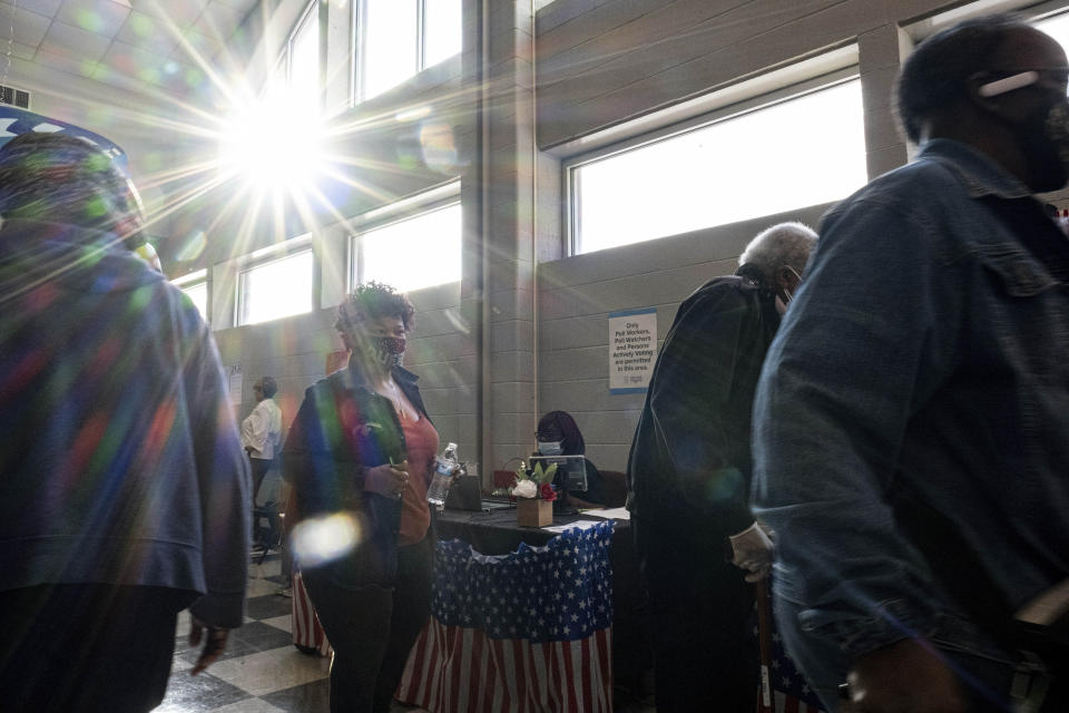 Voters make their way to the polls during the first day of early voting in Atlanta on Monday, Oct. 17, 2022. (AP Photo/Ben Gray)