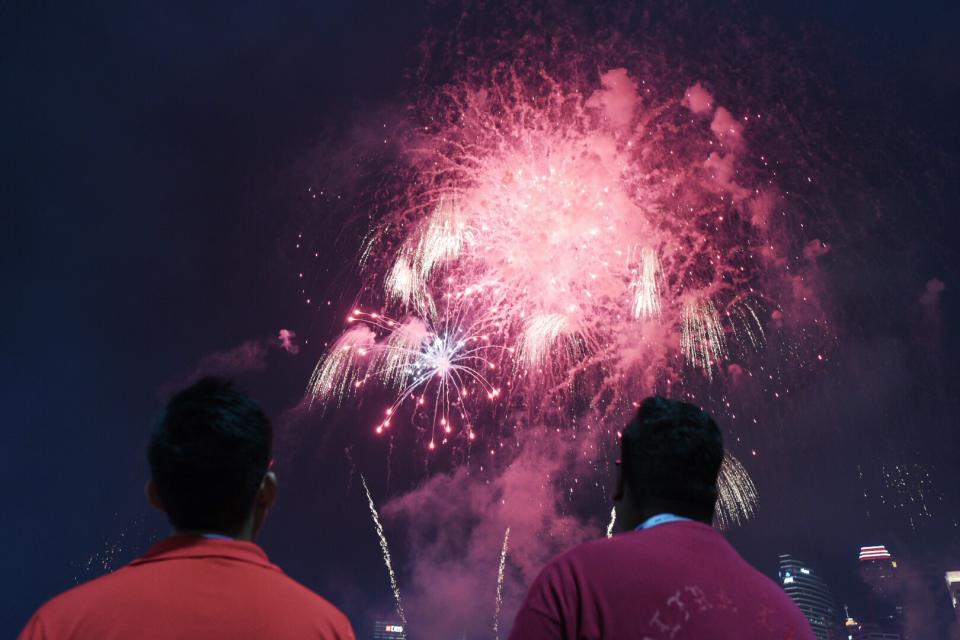 Spectators watch a fireworks display at the National Day Parade on 9 August 2018. PHOTO: Stefanus Ian/Yahoo News Singapore