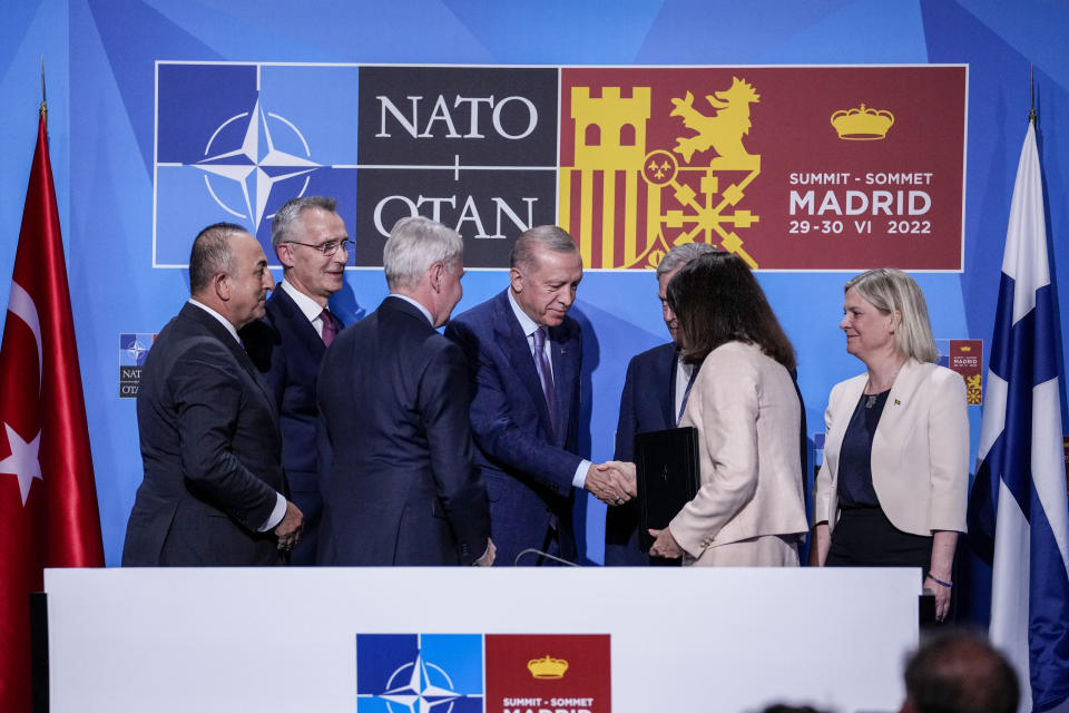 Turkish President Recep Tayyip Erdogan, center, shakes hands with Sweden's Foreign Minister Ann Linde next to NATO Secretary General Jens Stoltenberg, second left, Finland's President Sauli Niinisto, third right, and Sweden's Prime Minister Magdalena Andersson, right, after signing a memorandum in which Turkey agrees to Finland and Sweden's membership of the defense alliance in Madrid, Spain on Tuesday, June 28, 2022. North Atlantic Treaty Organization heads of state will meet for a summit in Madrid from Tuesday through Thursday. (AP Photo/Bernat Armangue)