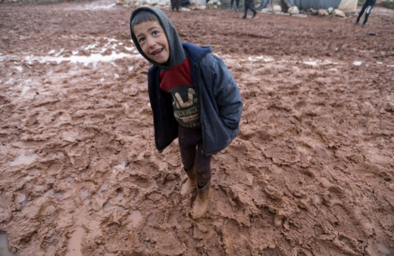 A boy walks in a mud in Azaz