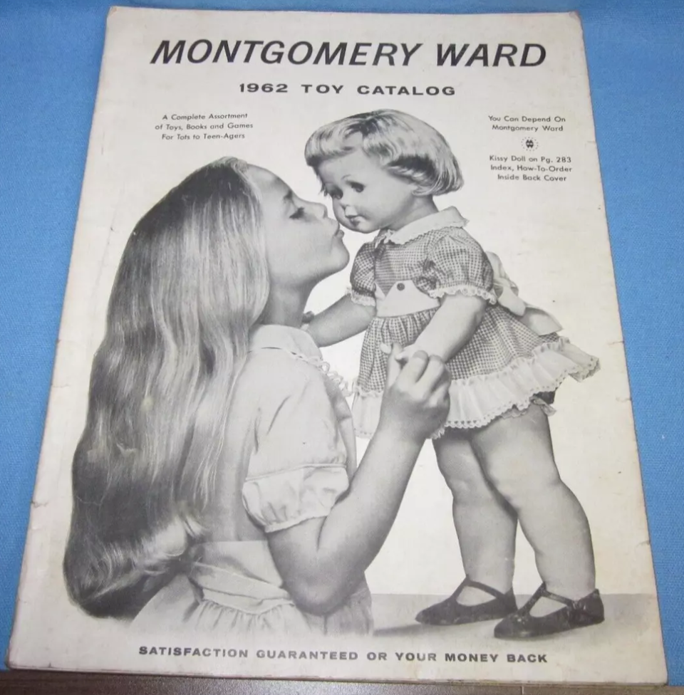 1962 Montgomery Ward toy catalog cover featuring a girl holding a large doll. Text: "A Complete Assortment of Toys, Books, and Games For Tots to Teen-Agers."