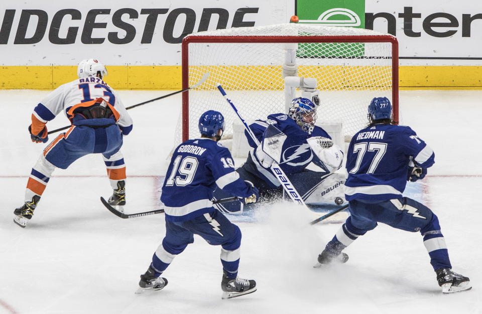 Tampa Bay Lightning goaltender Andrei Vasilevskiy (88) makes a save on New York Islanders center Mathew Barzal (13) during overtime in Game 5 of the NHL hockey Eastern Conference final, Tuesday, Sept. 15, 2020, in Edmonton, Alberta. (Jason Franson/The Canadian Press via AP)