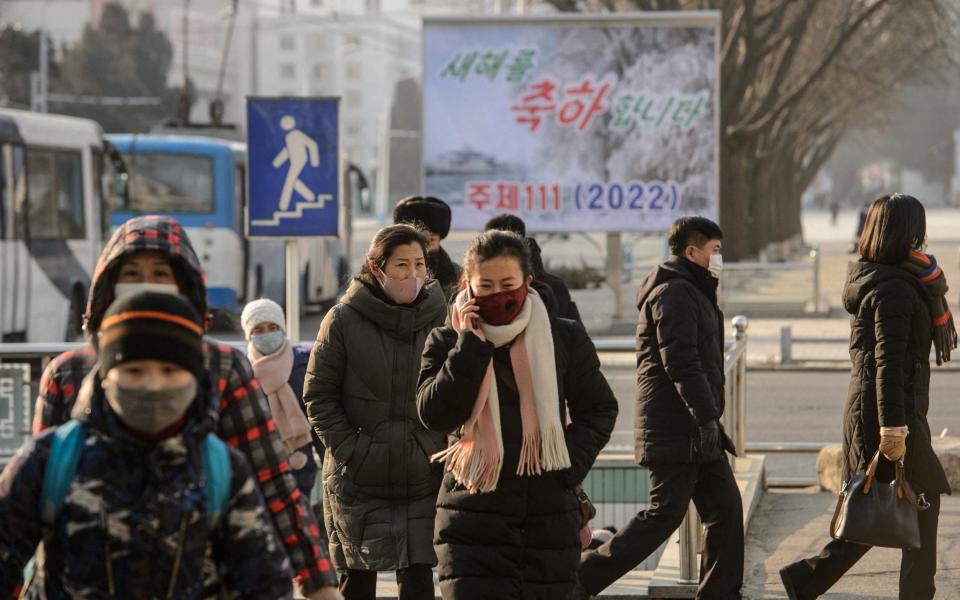 Pedestrians in Pyongyang on the day Kim Woo Joo made his boomerang defection - AFP