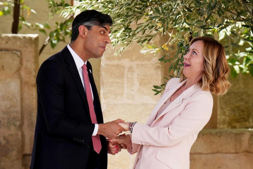 Rishi Sunak and Italian prime minister Giorgia Meloni embrace at the G7 summit (AP)