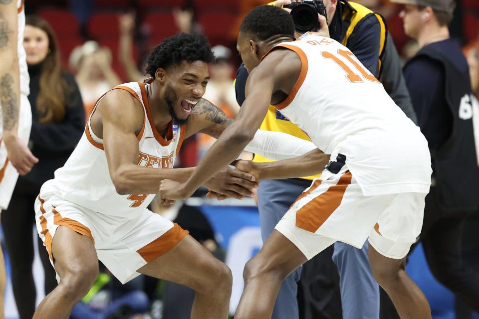 Texas guard Tyrese Hunter, left, and Jabari Rice celebrate the Longhorns' 71-66 win over Penn State. The last time Texas made it to the Sweet 16 was 2008.