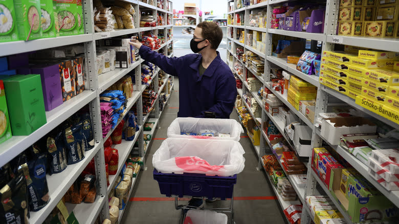 Worker fulfilling an order in a dark grocery store