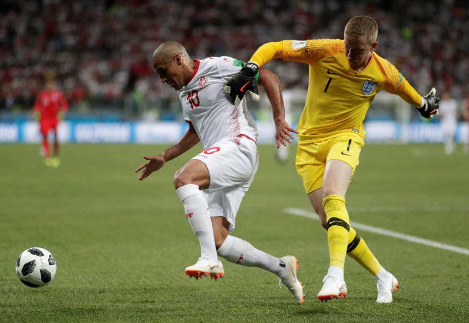 <p>Tunisia’s Wahbi Khazri tires to take on England’s Jordan Pickford (AP) </p>