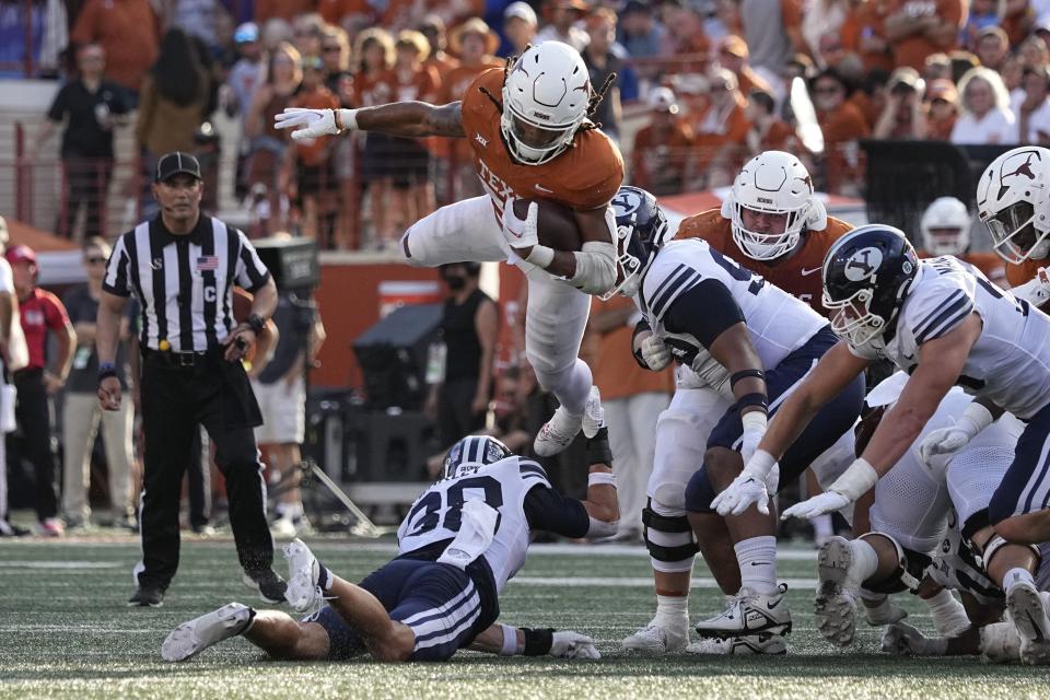 Texas running back Jonathon Brooks (24) is upended by BYU safety Crew Wakley (38) on a run during the second half of an NCAA college football game in Austin, Texas, Saturday, Oct. 28, 2023. | Eric Gay, Associated Press