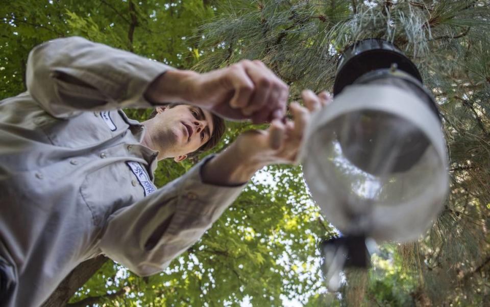 Bret Barner, a laboratory technician with the Sacramento-Yolo Mosquito & Vector Control District, places a trap for mosquitos at Seymour Park in the Pocket neighborhood on Wednesday, July 18, 2018. A resident found a dead crow that tested positive for West Nile Virus causing the district to capture and test for mosquitoes.