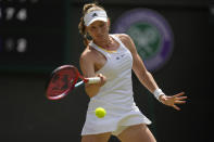 Kazakhstan's Elena Rybakina returns to Croatia's Petra Martic in a women's singles fourth round match on day eight of the Wimbledon tennis championships in London, Monday, July 4, 2022. (AP Photo/Alastair Grant)