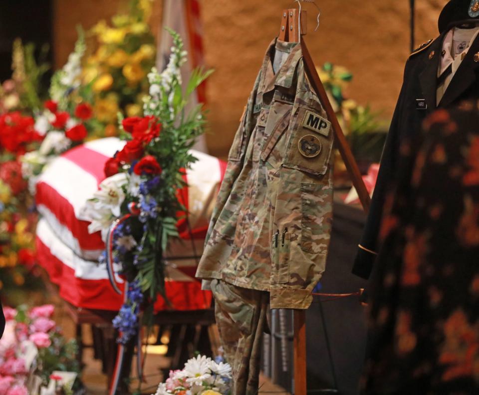 The uniforms of Kaylie Harris are hung beside her casket during her funeral service held Saturday, May 15, 2021 at the First Christian Church in Springfield, Ohio. Harris was an Army MP stationed in Anchorage. She alleged that she was raped by a colleague, an Airman, in January shortly after coming out on social media. Harris's family believes the rape was also a hate crime directed at her because she was lesbian. She printed a suicide note on May 2, 2021 and was found later that day with a gunshot wound to her head. 