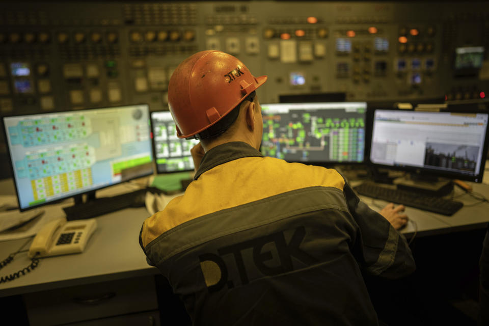 A worker transmits the parameters from the control panel of the power plant in central Ukraine, Thursday, Jan. 5, 2023. When Ukraine was at peace, its energy workers were largely unheralded. War made them heroes. They're proving to be Ukraine's line of defense against repeated Russian missile and drone strikes targeting the energy grid and inflicting the misery of blackouts in winter. (AP Photo/Evgeniy Maloletka)