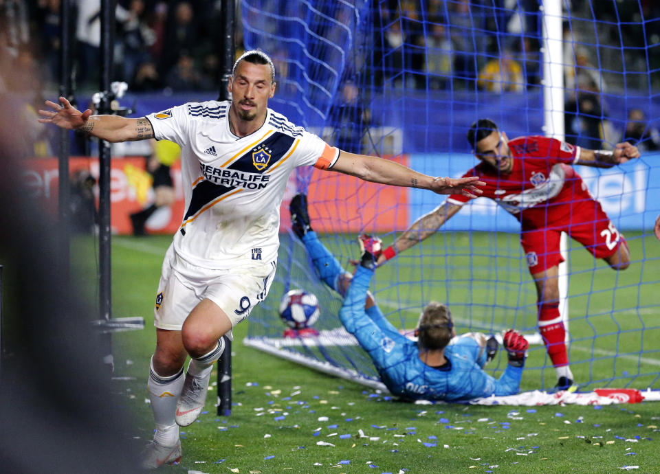 LA Galaxy forawrd Zlatan Ibrahimovic, left, of Sweden, celebrates his goal against the Chicago Fire in the second half of an MLS soccer match in Carson, Calif., Saturday, March 2, 2019. (AP Photo/Ringo H.W. Chiu)