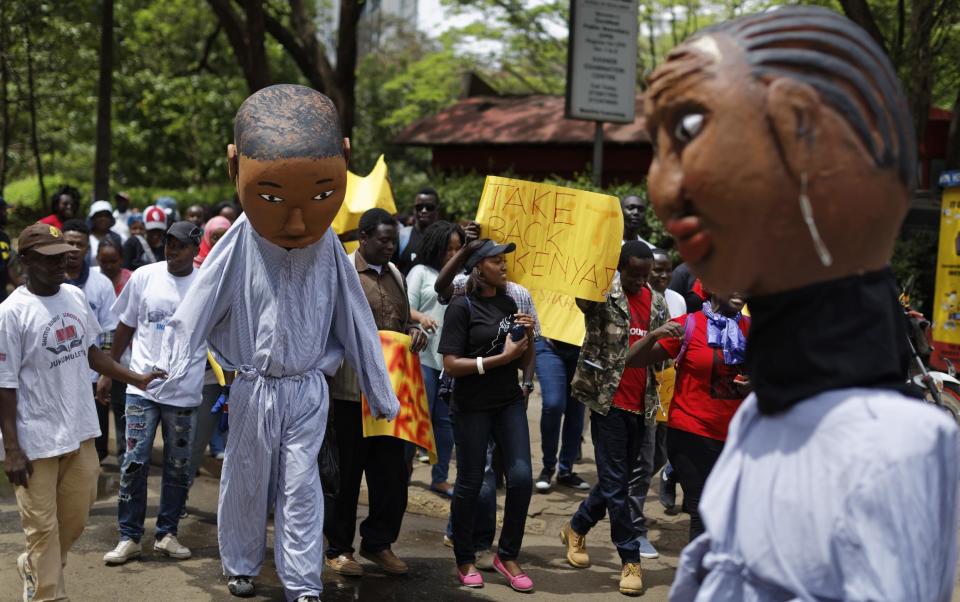 Protesters march against government corruption, on the 53rd anniversary of Kenya's independence, in downtown Nairobi, Kenya Monday, Dec. 12, 2016. Kenya's president on Monday criticized the International Criminal Court as "not impartial," saying his government "will give serious thought" to its membership of the court. (AP Photo/Ben Curtis)