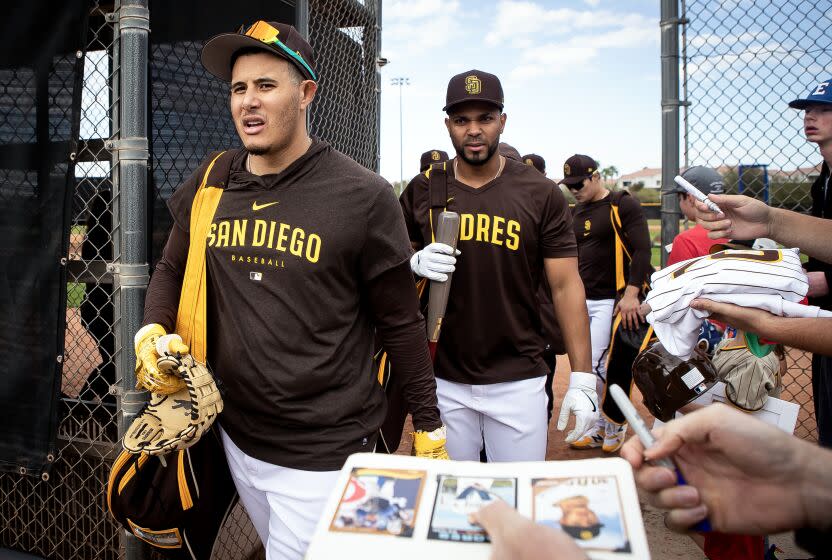 Peoria, AZ - February 21: Padres third baseman Manny Machado (13) and shortstop Xander Bogaerts (2) and shortstop Ha-Seong Kim (7) exit the field as fans beg for autographs during a spring training practice at the Peoria Sports Complex on Tuesday, Feb. 21, 2023 in Peoria, AZ. (Meg McLaughlin / The San Diego Union-Tribune)