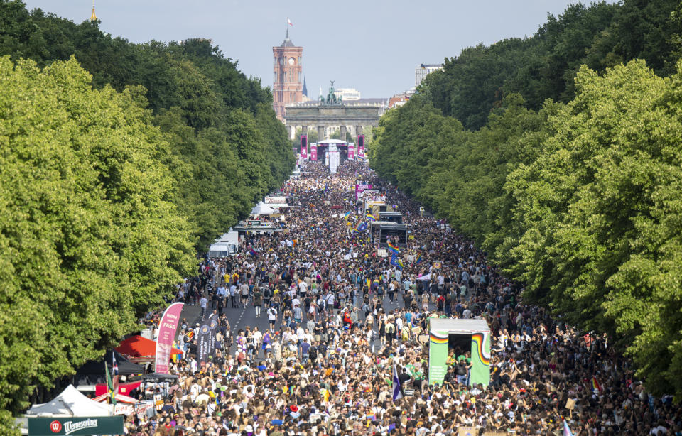 People march in Berlin, Saturday, July 23, 2022. Draped in rainbow flags, around 150,000 people were marching for LGBTQ rights at Berlin’s annual Christopher Street Day celebration. Berlin police gave the crowd estimate on Saturday afternoon but said the number could grow into the evening. (Monika Skolimowska/dpa via AP)