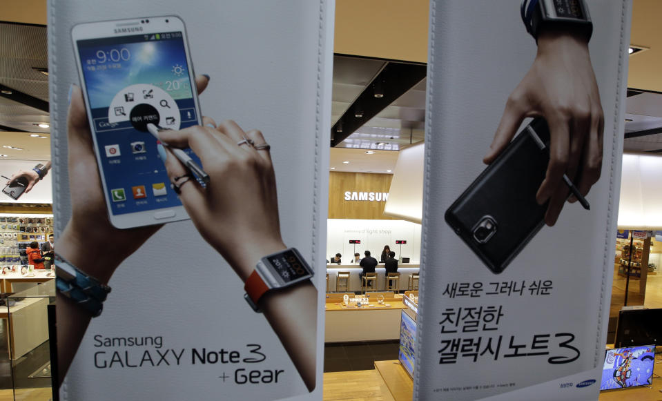 In this photo taken on Jan. 7, 2014, billboard for Samsung Electronics' Galaxy Note 3 hang at a showroom of Samsung Electronics in Seoul, South Korea. For the first time in more than two years, Samsung's quarterly net profit declined from the previous quarter, the South Korean electronics powerhouse said Friday, Jan. 24, 2014, amid deepening concerns about slowing growth in smartphone markets. (AP Photo/Lee Jin-man)