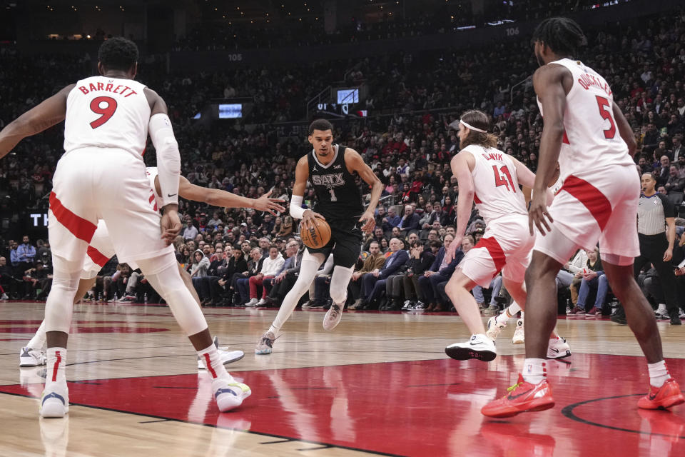 San Antonio Spurs' Victor Wembanyama drives against the Toronto Raptors defense during first-half NBA basketball game action in Toronto, Monday Feb. 12, 2024. (Chris Young/The Canadian Press via AP)