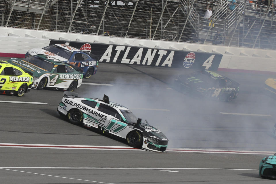 Chris Buescher (17) slides down the track during the NASCAR auto race at Atlanta Motor Speedway Sunday, Feb. 25, 2024, in Hampton , Ga. (AP Photo/Skip Williams)