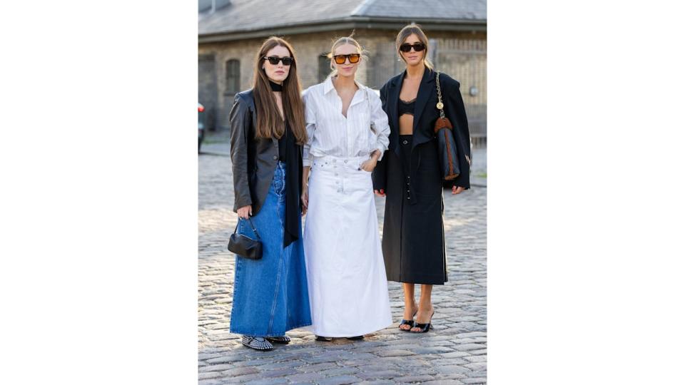 Annabel Rosendahl, Tine Andrea and Darja Barannik wearing the transitional staple: the maxi skirt outside the Ganni show in Copenhagen. 