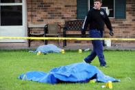 A police investigator is at the scene of a stabbing and shooting at a home in Sunset, Louisiana, August 26, 2015. Police stormed a grocery market in a southwestern Louisiana town on Wednesday to arrest a man accused of stabbing two people and shooting an officer before barricading himself inside the store, the St. Landry Parish sheriff said. (REUTERS/Leslie Westbrook/The Advocate)