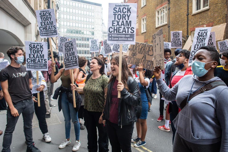 People take part in a protest marching from Downing Street to the Department of Education in Westminster, London, over the government's handling of A-level results. Thousands of pupils across England have expressed their disappointment at having their results downgraded after exams were cancelled due to coronavirus. Picture date: Friday August 14, 2020. Photo credit should read: Matt Crossick/Empics