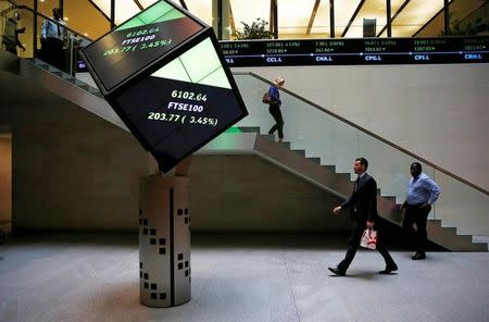 People walk through the lobby of the London Stock Exchange in London, Britain August 25, 2015. REUTERS/Suzanne Plunkett/File photo