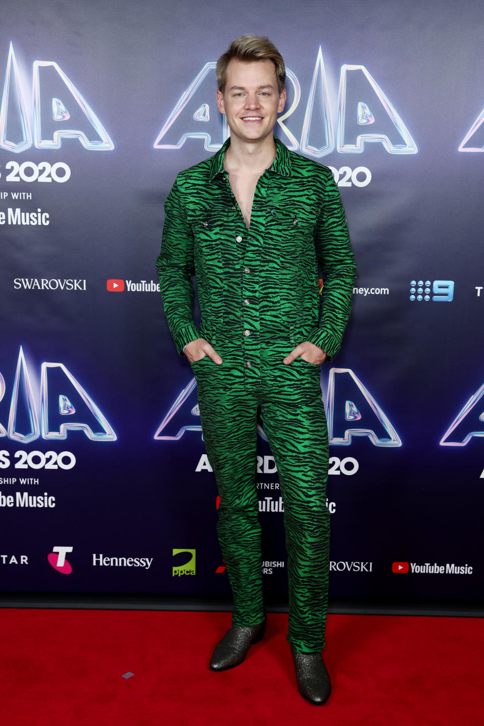 Joel Creasey wears a green zebra print boiler-suit by Kenzo on the red carpet at the 2020 ARIA Awards at The Star on November 24, 2020 in Sydney, Australia.