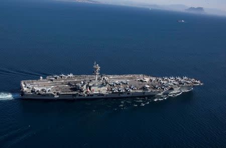 FILE PHOTO: The Nimitz-class aircraft carrier USS Abraham Lincoln (CVN 72) transits the Strait of Gibraltar, entering the Mediterranean Sea as it continues operations in the 6th Fleet area of responsibility in this April 13, 2019. U.S. Navy/Mass Communication Specialist 2nd Class Clint Davis/Handout via REUTERS