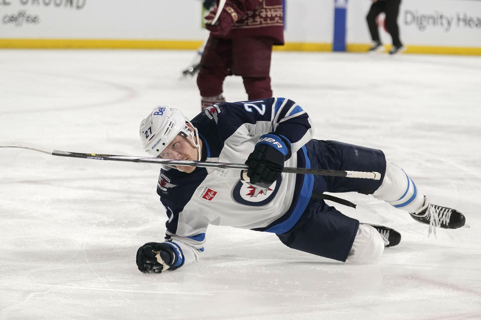 Winnipeg Jets' Nikolaj Ehlers (27) falls to the ice after scoring against the Arizona Coyotes during the second period of an NHL hockey game Sunday, Jan. 7, 2024, in Tempe, Ariz. (AP Photo/Darryl Webb)