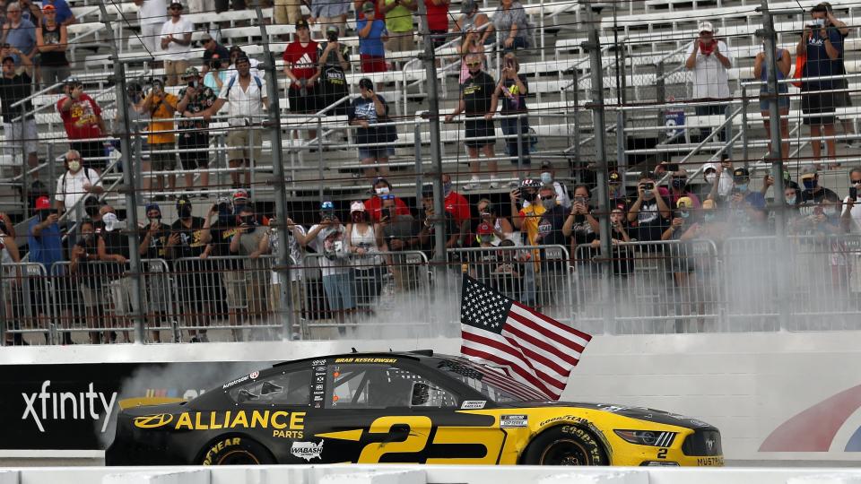 Driver Brad Keselowski celebrates with a burnout and the American flag after winning during a NASCAR Cup Series auto race, Sunday, Aug. 2, 2020, at the New Hampshire Motor Speedway in Loudon, N.H. (AP Photo/Charles Krupa)