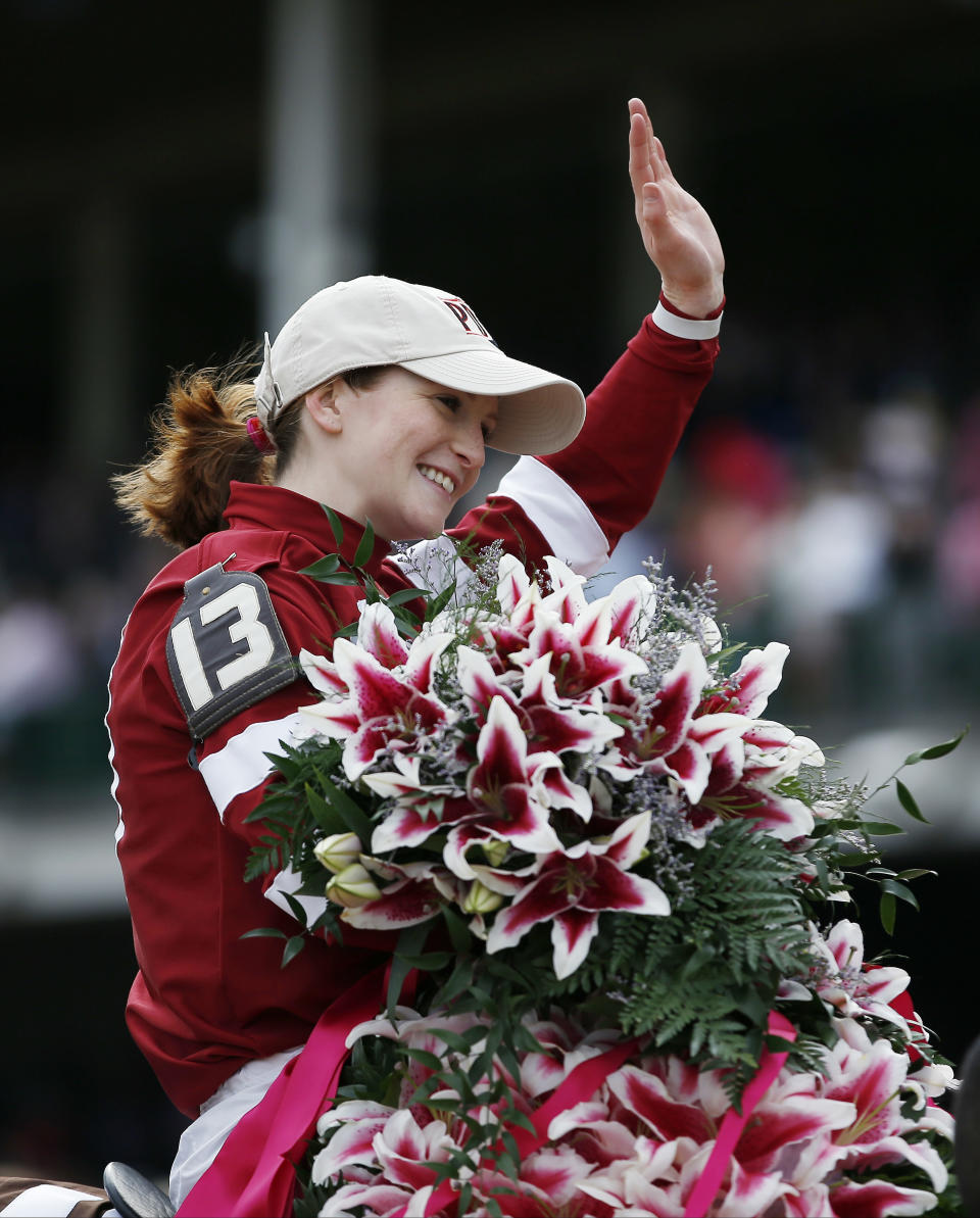Rosie Napravnik celebrates after riding Untapable to victory during the 140th running of the Kentucky Oaks horse race at Churchill Downs Friday, May 2, 2014, in Louisville, Ky. (AP Photo/Matt Slocum)