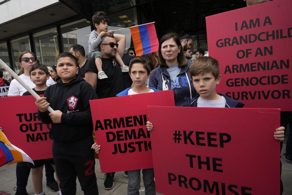People hold signs as Armenian Americans commemorate the 108th anniversary of the Armenian Genocide Remembrance Day with a protest outside the Consulate of Turkey in Beverly Hills, Calif., Monday, April 24, 2023. (AP Photo/Damian Dovarganes)
