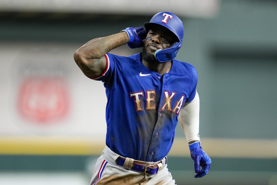 Texas Rangers' Adolis Garcia reacts after hitting a home run during the eighth inning of Game 7 of the baseball AL Championship Series against the Houston Astros Monday, Oct. 23, 2023, in Houston. (AP Photo/Godofredo A. Vásquez)