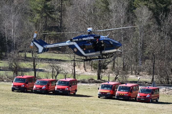 A French Gendarmeri helicopter flies over an air base in Seyne-les-Alpes on March 26, 2015 as the search operation following the Germanwings plane crash resumes (AFP Photo/Boris Horvat)