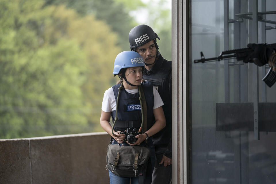 This image released by A24 shows Cailee Spaeny, left, and Wagner Moura in a scene from "Civil War." (Murray Close/A24 via AP)