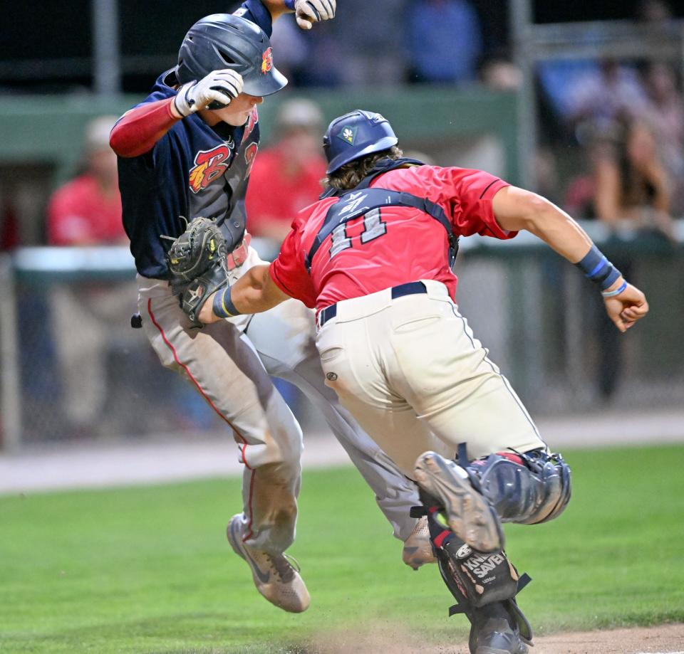 HARWICH   7/29/22   Mac Horvath of Bourne is caught coming home by Harwich catcher Bryan Arendt ending the side in the sixth inning.  for a photo gallery : https://www.capecodtimes.com/news/photo-galleries/