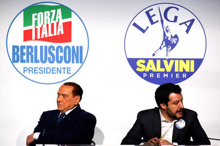 Forza Italia leader Silvio Berlusconi sits next to Northern League leader Matteo Salvini during a meeting in Rome, Italy, March 1, 2018. REUTERS/Alessandro Bianchi/Files