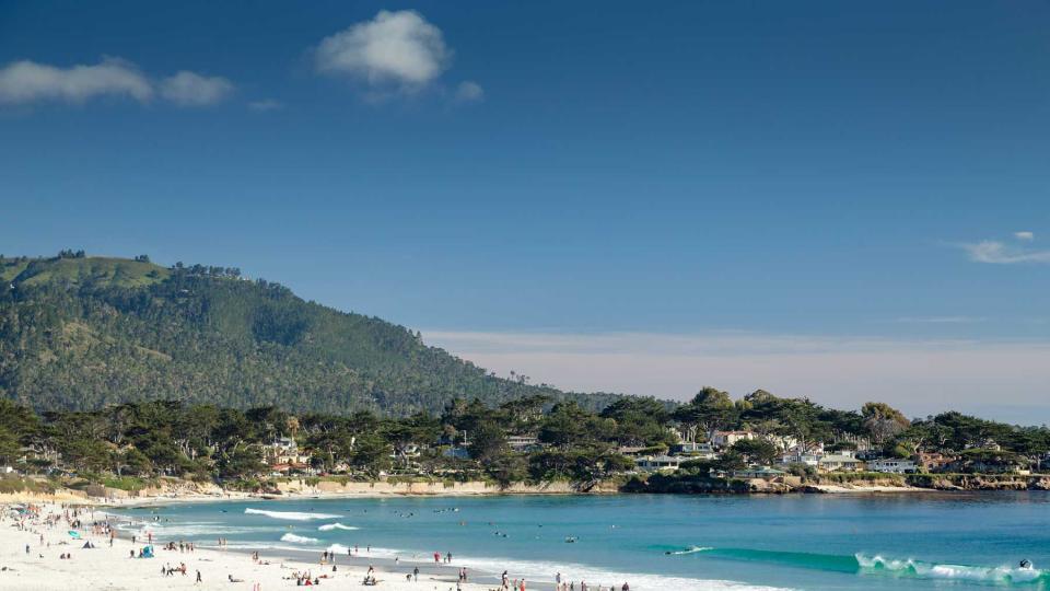 People enjoying the golden sands of Carmel beach on a warm spring day, Carmel, California.