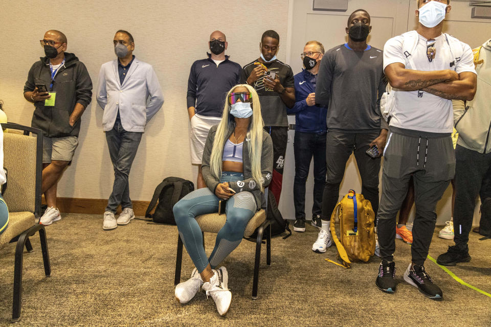 Sha'carri Richardson, seated, attends a news conference Friday, Aug. 20, 2021, a day before competing in the 100 meters at the Pre Classic track and field meet in Eugene, Ore. (AP Photo/Thomas Boyd)