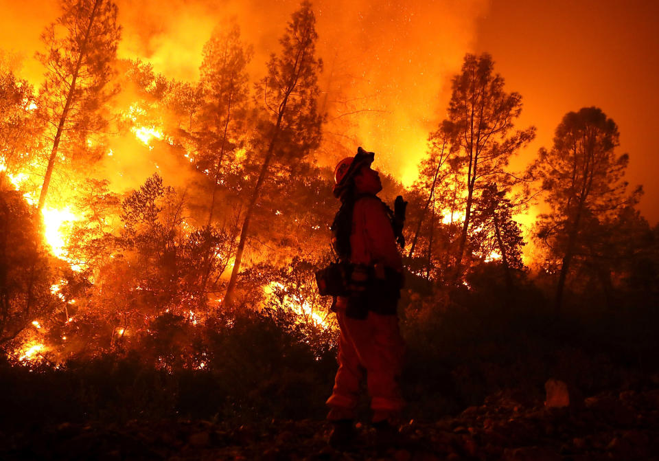 A firefighter monitors a backfire while battling the Mendocino Complex blaze on Aug. 7 near Lodoga, California. So far this year, six people have died fighting wildfires in the state. (Photo: Justin Sullivan / Getty Images)