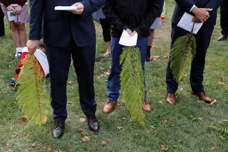 People hold ferns during a vigil for the victims of the mosque attacks during an ecumenical celebration in Christchurch, New Zealand, March 21, 2019. REUTERS/Jorge Silva